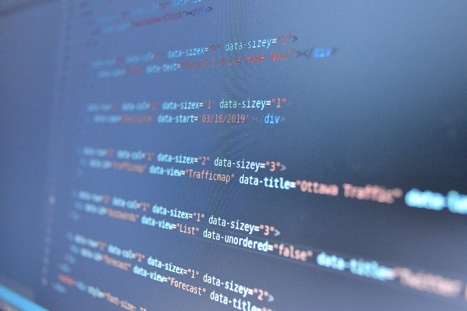 Blurred lines of program code on a dark screen